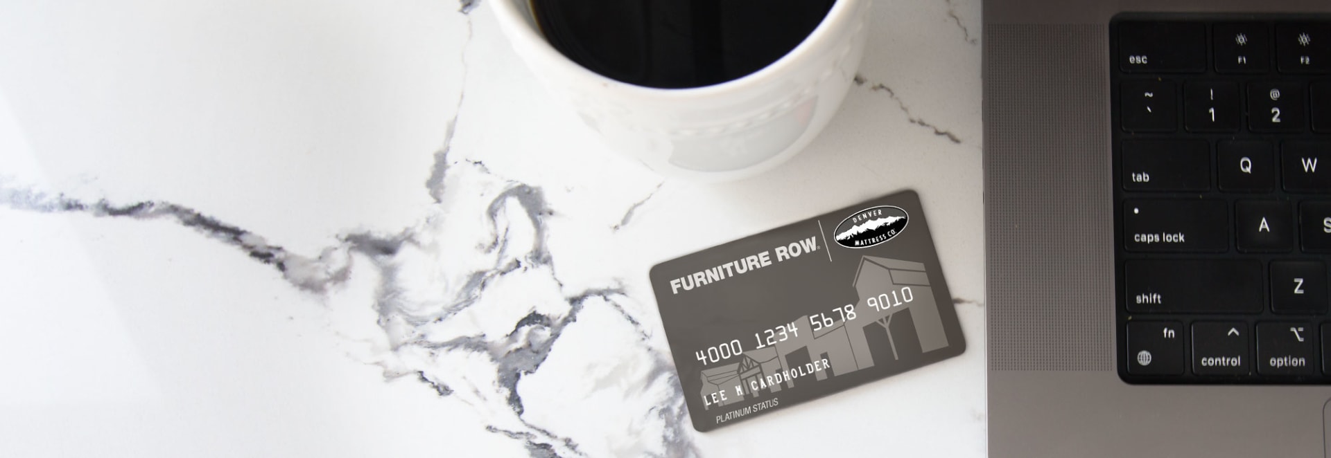 Furniture Row Credit Card Next to computer with coffee cup